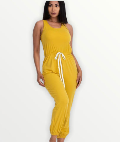 Mustard colored sleeveless jumpsuit with elasticized waist and jogger hem. 95% polyester and 5% spandex. Available in small, medium, and large.