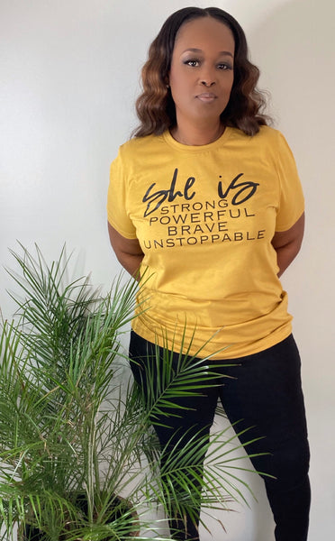 100% cotton mustard color unisex tshirt with SHE IS Strong,Powerful, Brave, Unstoppable wording.