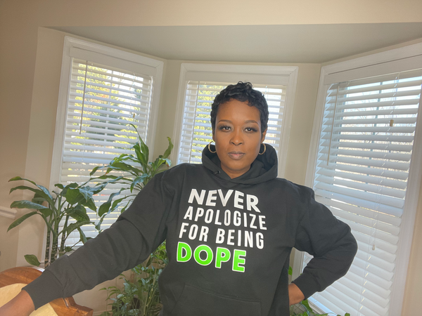 Black Hooded Sweatshirt with Matching Drawstrings and Front Pouch Pocket with the words Never Apologize For being Dope on the front. . Cotton Polyester Blend Available in S, M, L, XL