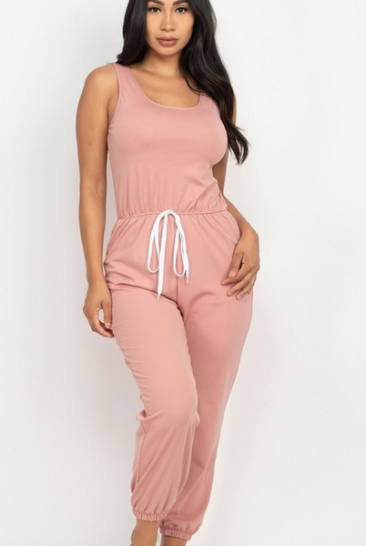 Mauve colored sleeveless jumpsuit with elasticized waist and jogger hem. 95% polyester and 5% spandex. Available in small, medium, and large.